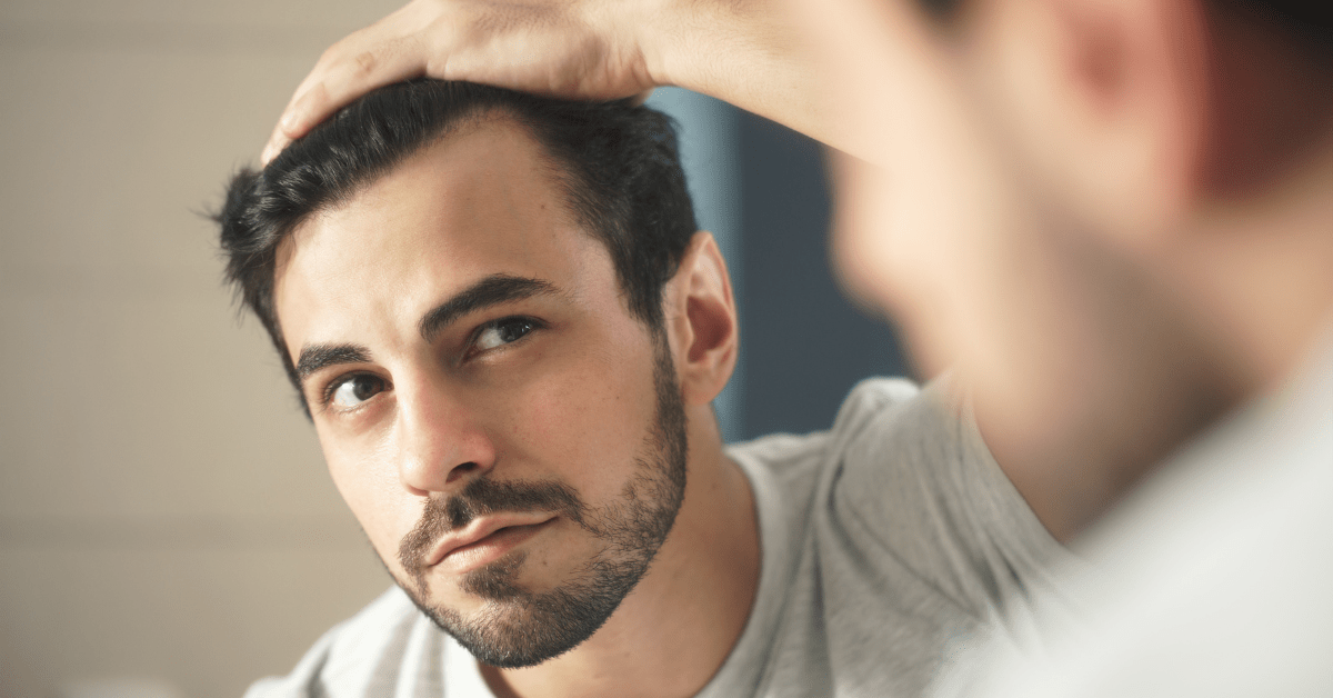 2 Man looking at hair loss in the mirror. Austin Regenerative Therapy uses PRP Hair Restoration for hair loss.