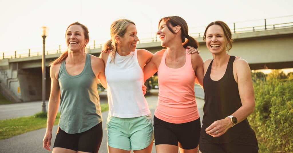 group of ladies walking with arms around each other