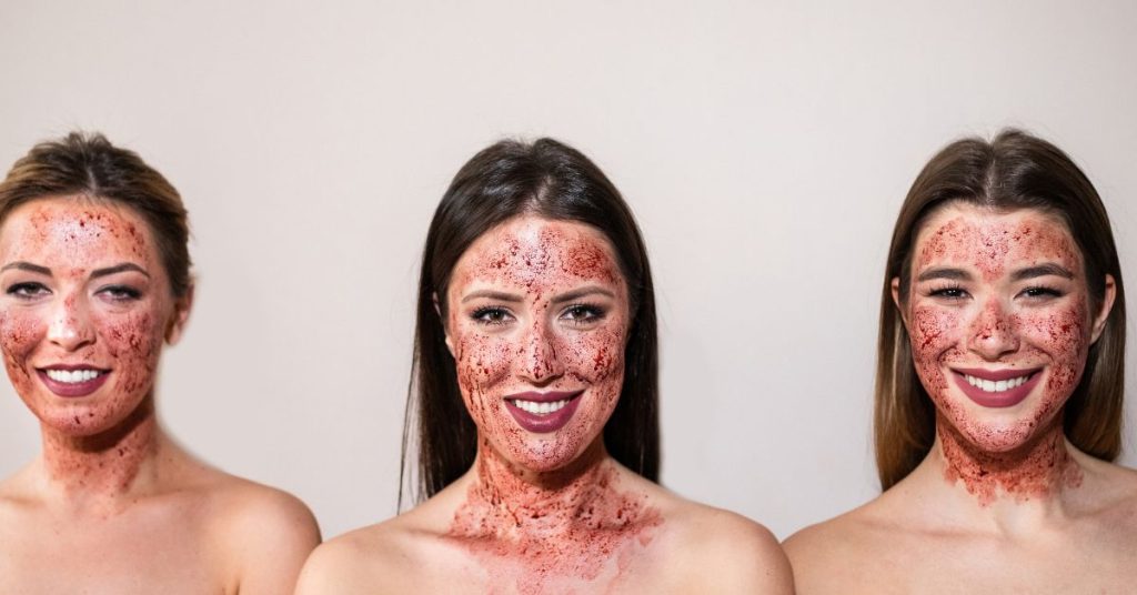 ladies with blood on their face illustrating a vampire facial